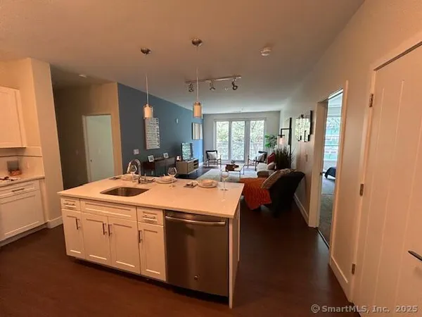 a large white kitchen with a large window