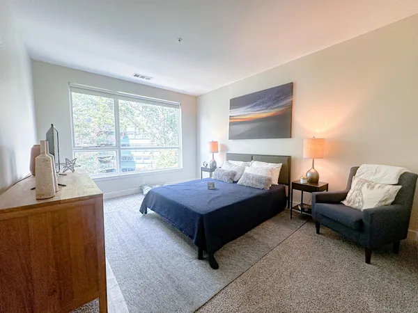 a bedroom with a bed and window