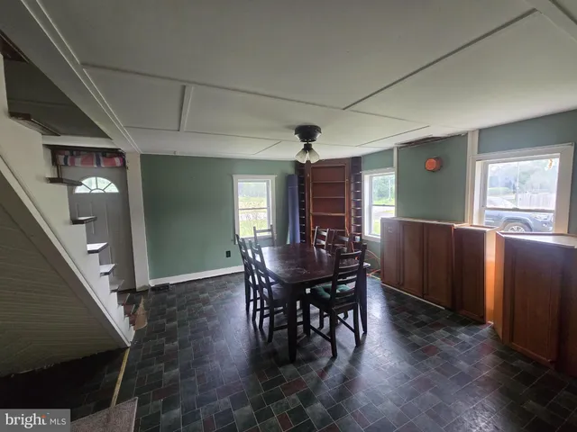 a view of a dining room with furniture and window