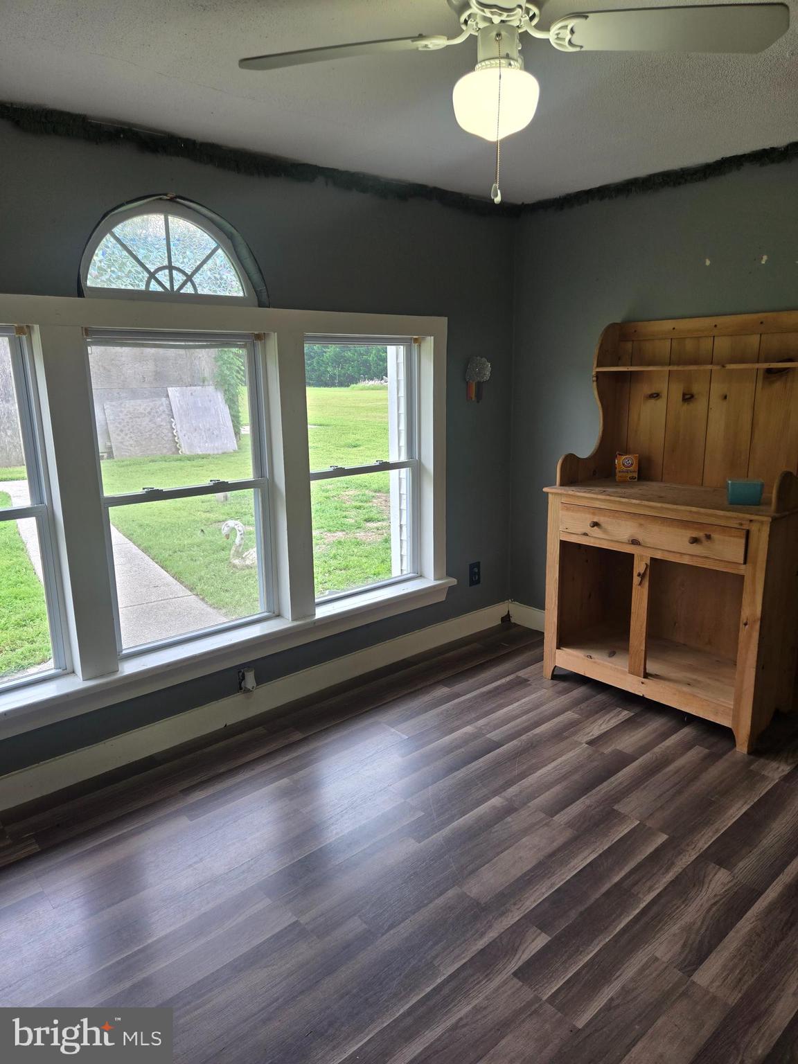96 Main Street Heislerville, NJ 08324 - Photo 12 of 14 a view of an empty room with wooden floor a fireplace and a window