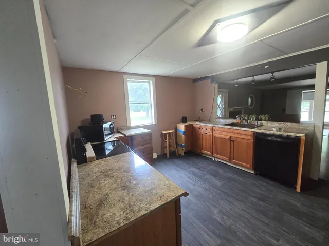 a view of a kitchen with sink cabinets and wooden floor