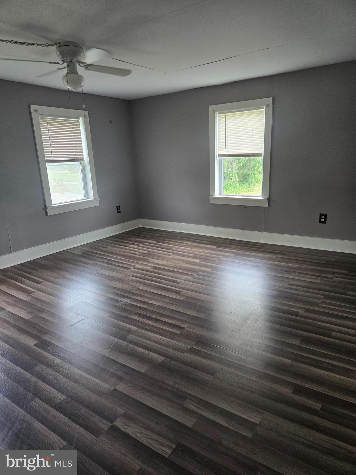 96 Main Street Heislerville, NJ 08324 - Photo 7 of 14 an empty room with wooden floor and windows