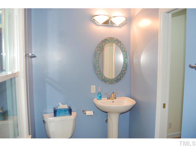 3317 Octavia Street Raleigh, NC 27606 - Photo 12 of 25 The attached bath is grounded with tile floors and has a tile surround shower and pedestal sink.