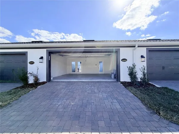 a view of a house with a yard and garage