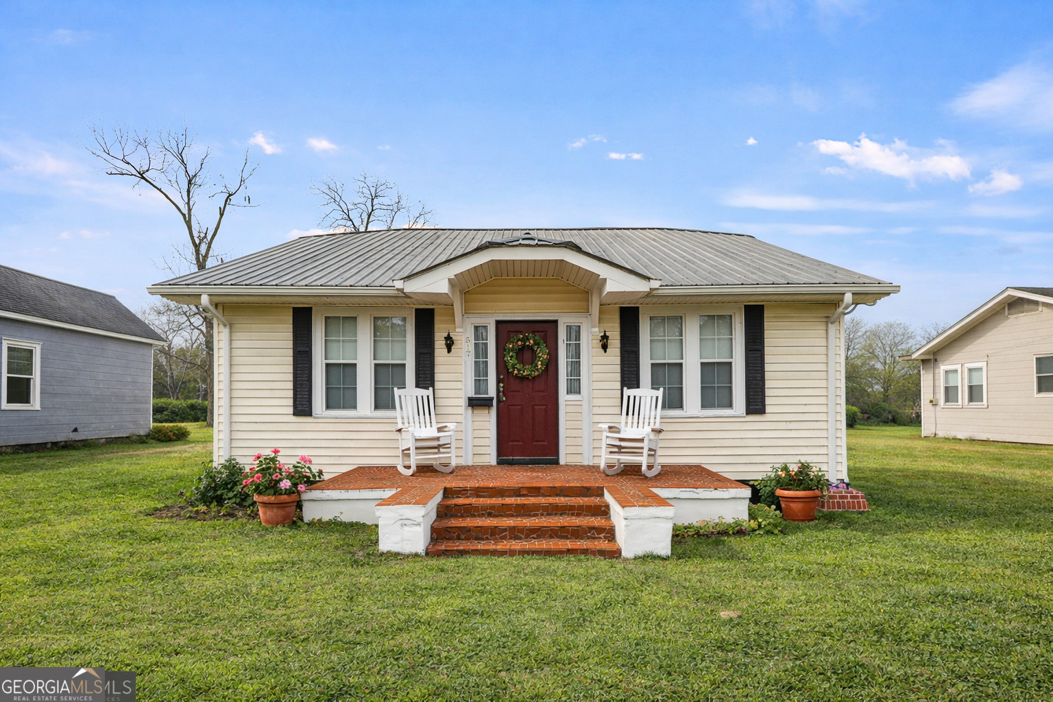 517 North Masonic Street Millen, GA 30442 - Photo 1 of 40 a front view of a house with a garden