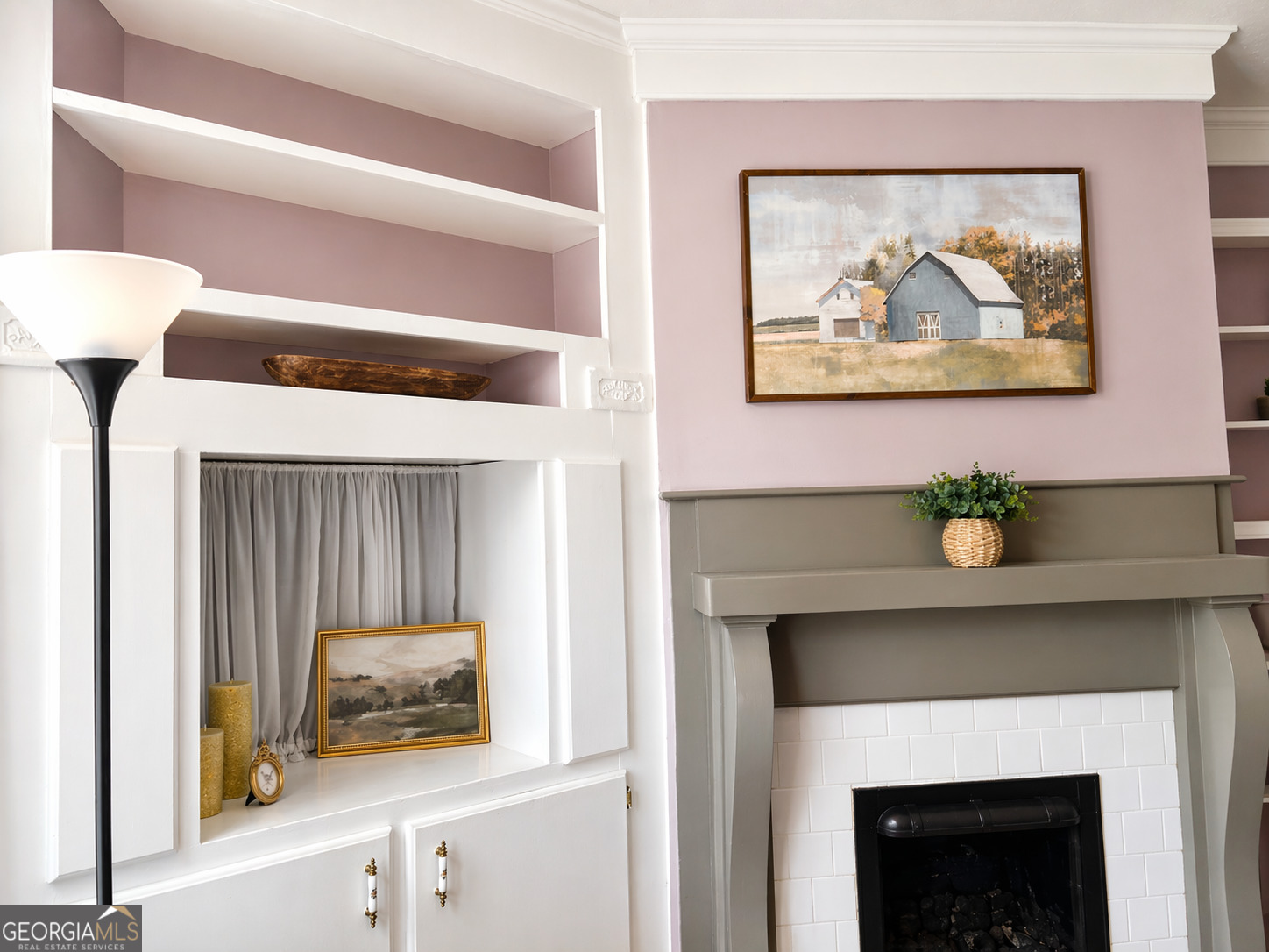 517 North Masonic Street Millen, GA 30442 - Photo 13 of 40 a living room with a fireplace and a painting on the wall