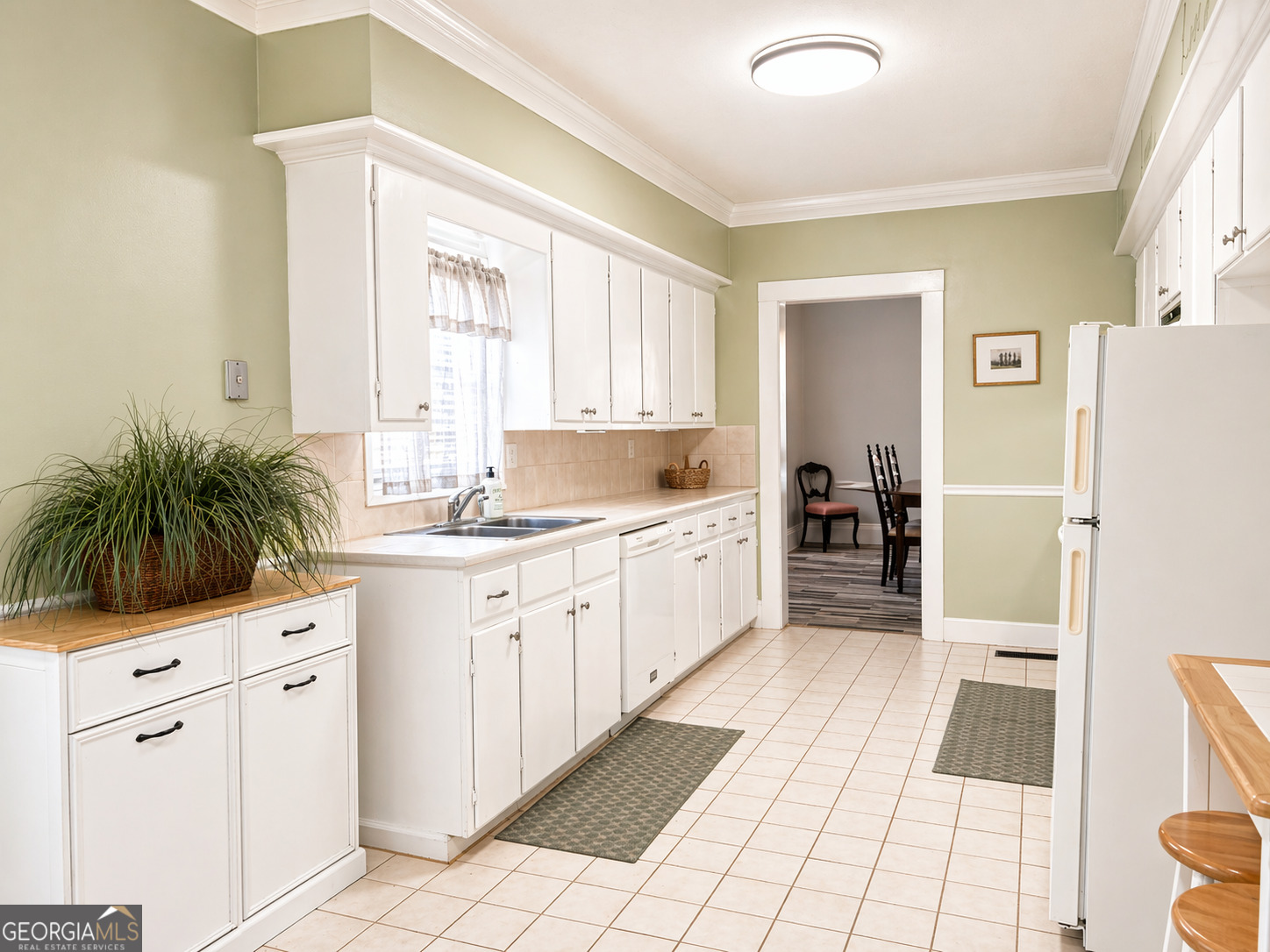 517 North Masonic Street Millen, GA 30442 - Photo 19 of 40 a large white kitchen with cabinets and appliances