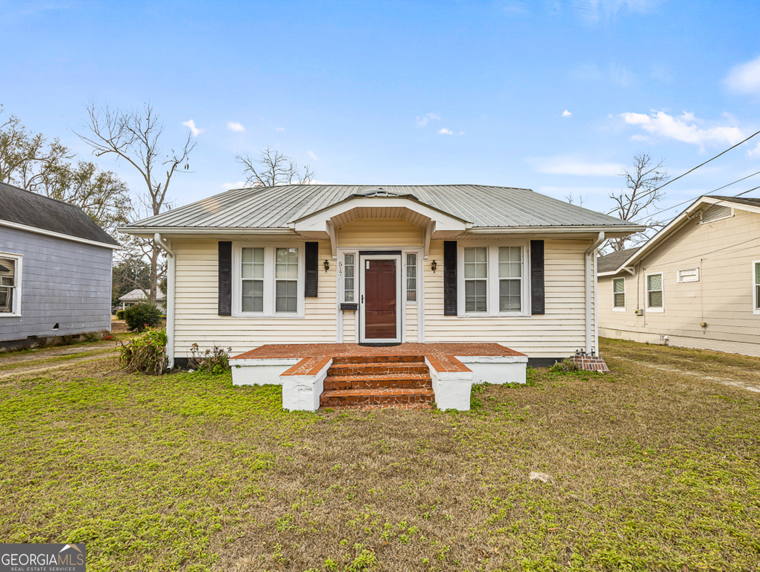 517 North Masonic Street Millen, GA 30442 - Photo 2 of 40 a front view of a house with swimming pool