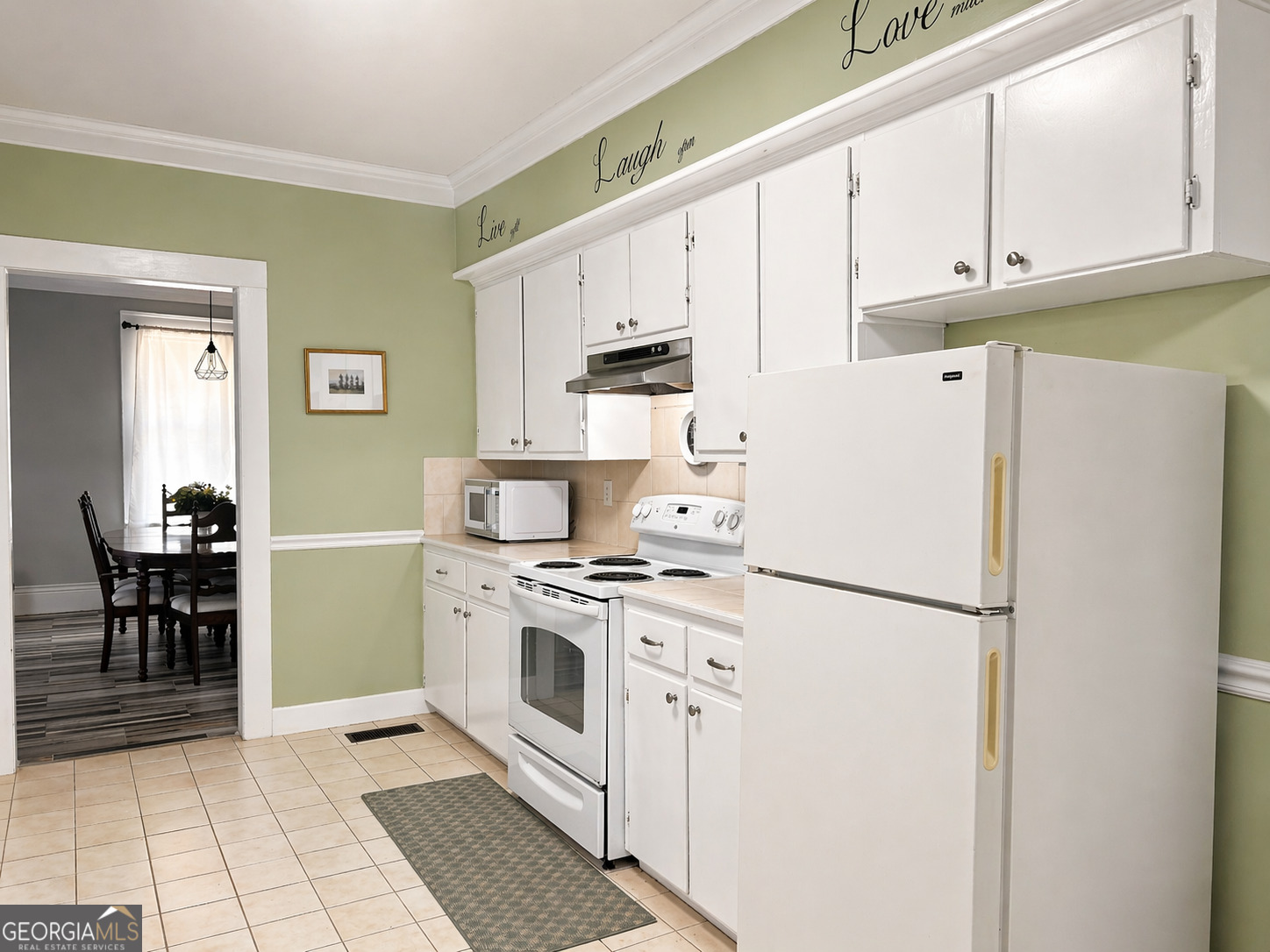 517 North Masonic Street Millen, GA 30442 - Photo 21 of 40 a kitchen with a white cabinets and white appliances