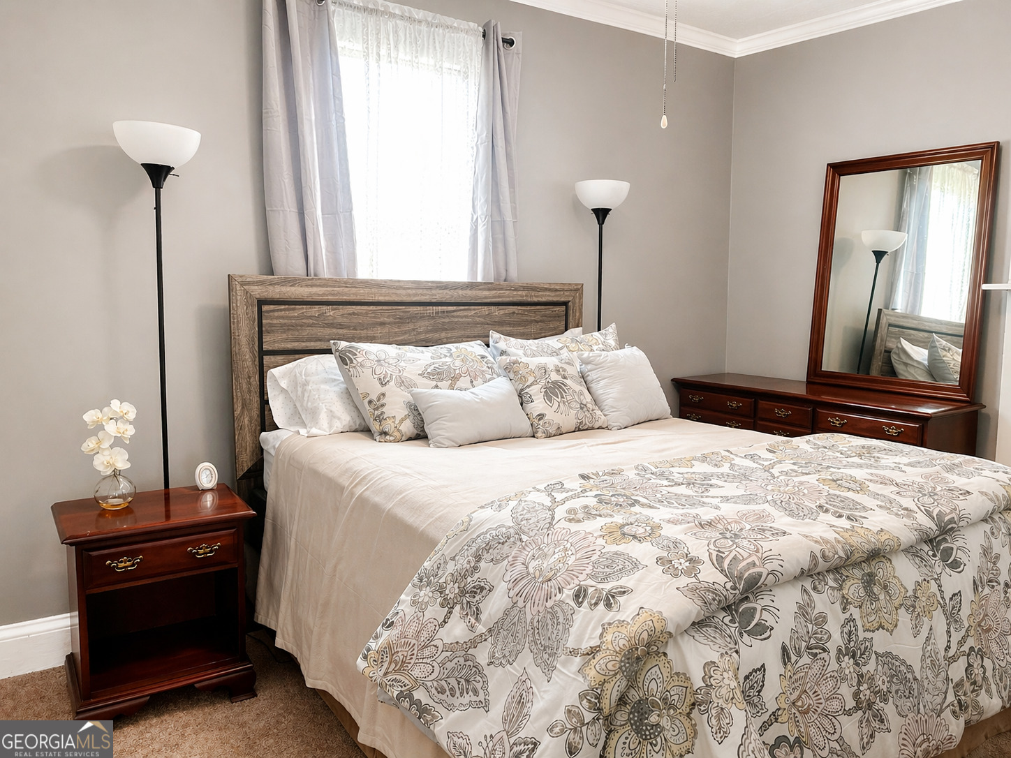 517 North Masonic Street Millen, GA 30442 - Photo 26 of 40 a bedroom with a bed and a mirror