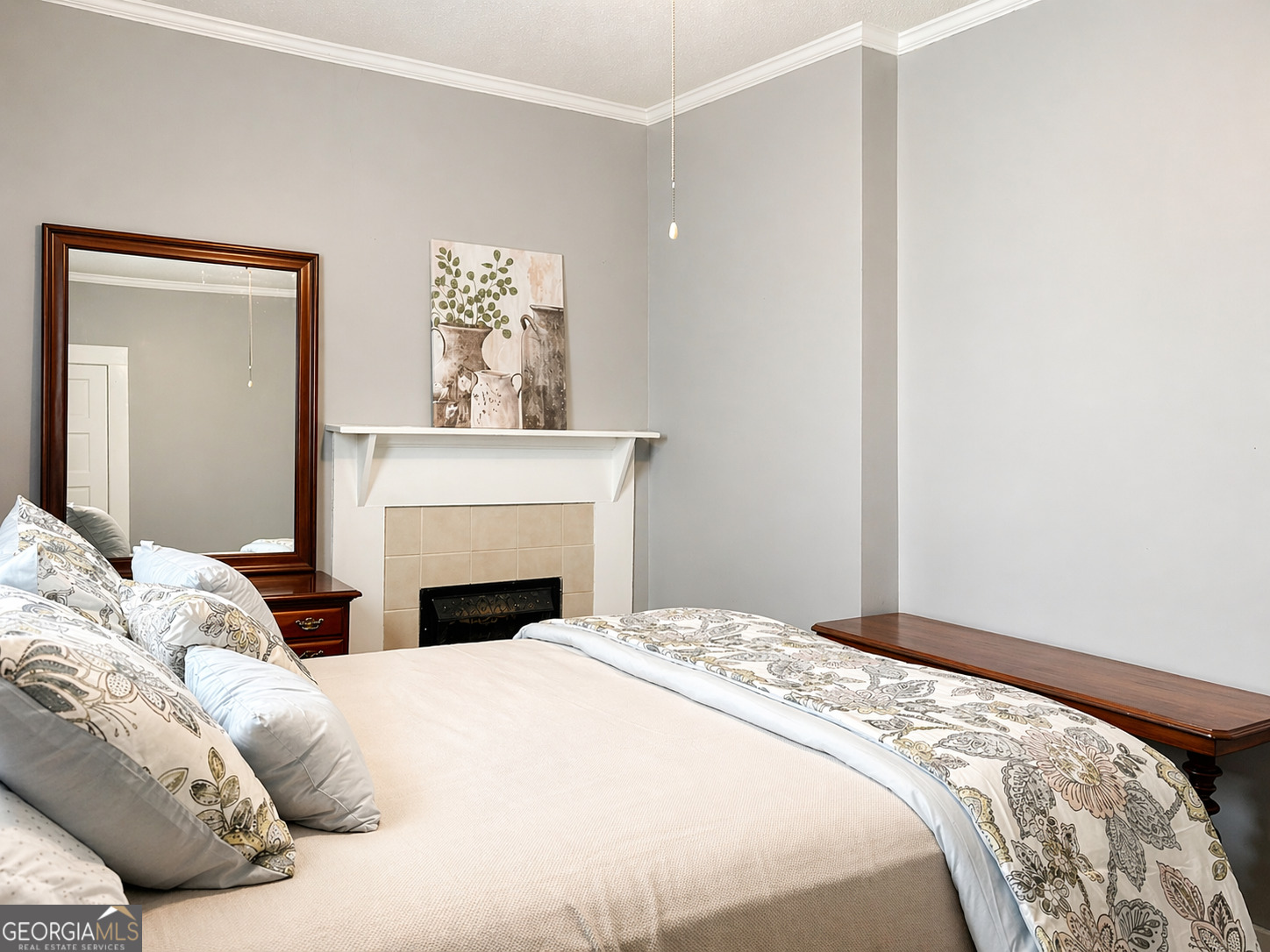 517 North Masonic Street Millen, GA 30442 - Photo 27 of 40 a bedroom with a bed and a fireplace