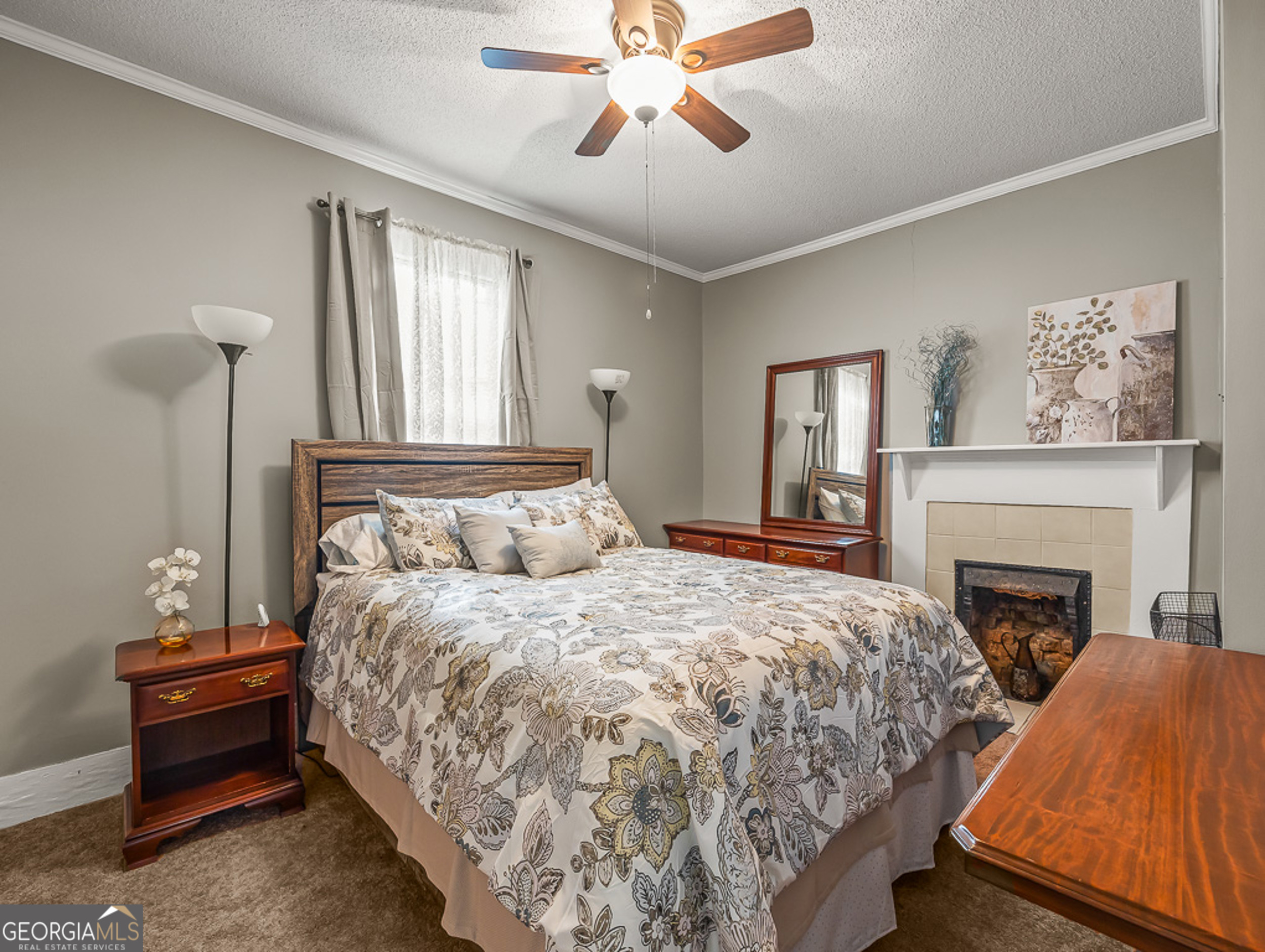 517 North Masonic Street Millen, GA 30442 - Photo 28 of 40 a bedroom with a bed and a fireplace
