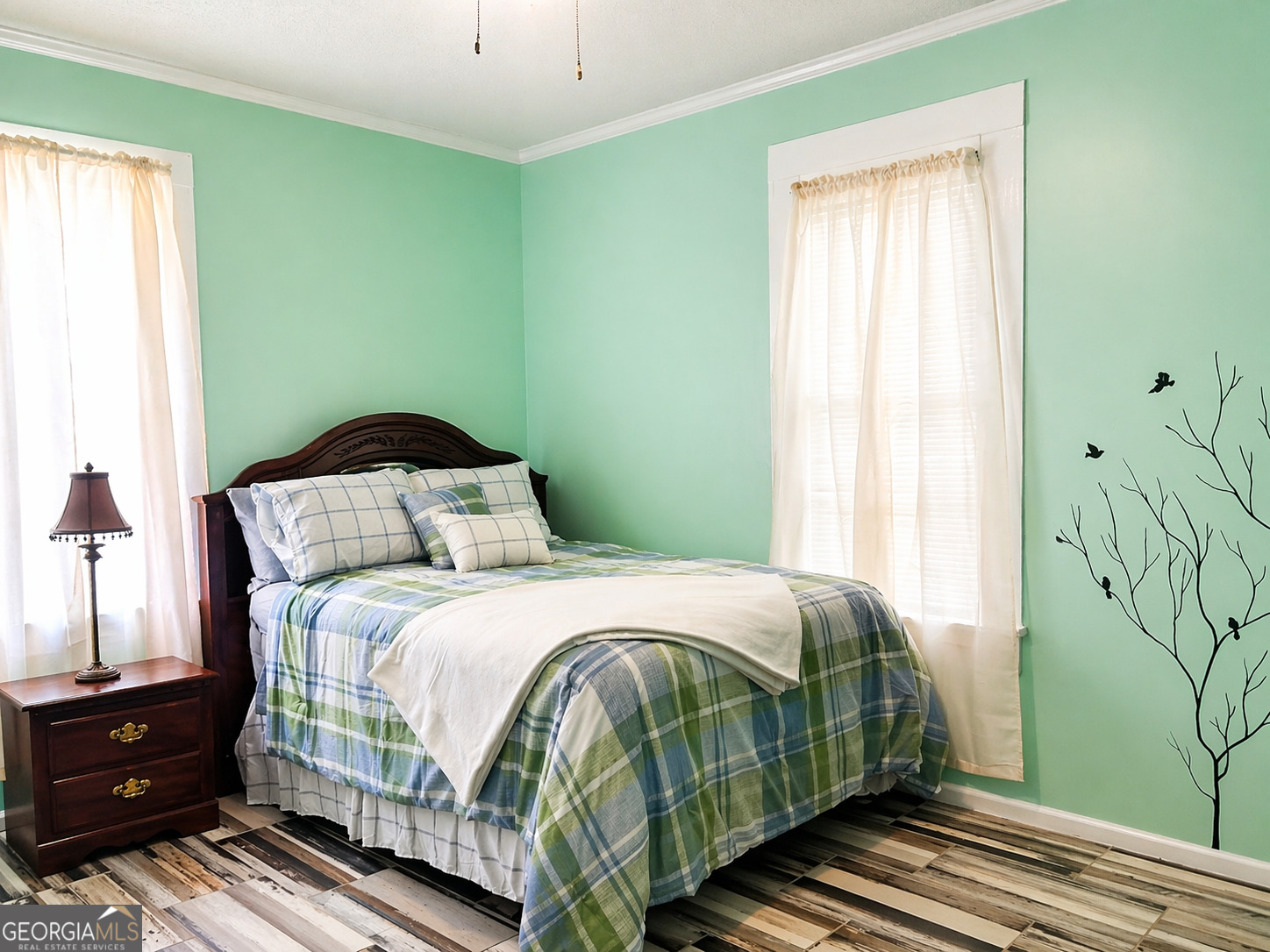 517 North Masonic Street Millen, GA 30442 - Photo 29 of 40 a bedroom with a bed and a window