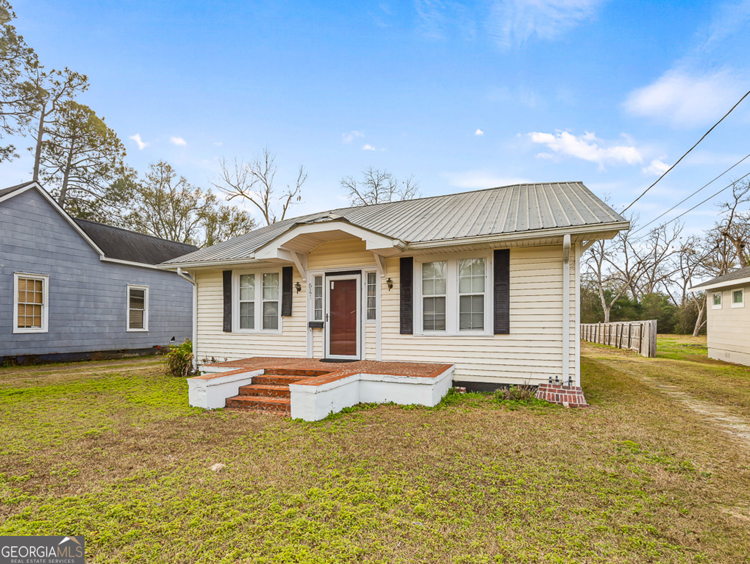 517 North Masonic Street Millen, GA 30442 - Photo 3 of 40 a front view of a house with a yard balcony