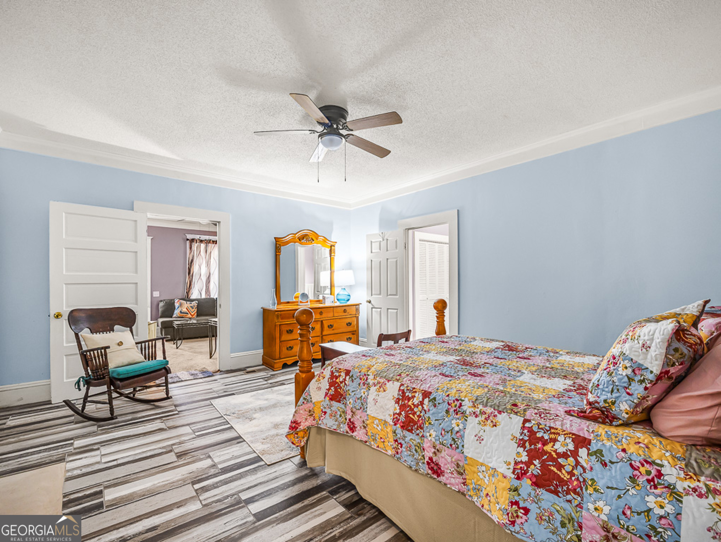 517 North Masonic Street Millen, GA 30442 - Photo 33 of 40 a bedroom with a bed and wooden floor