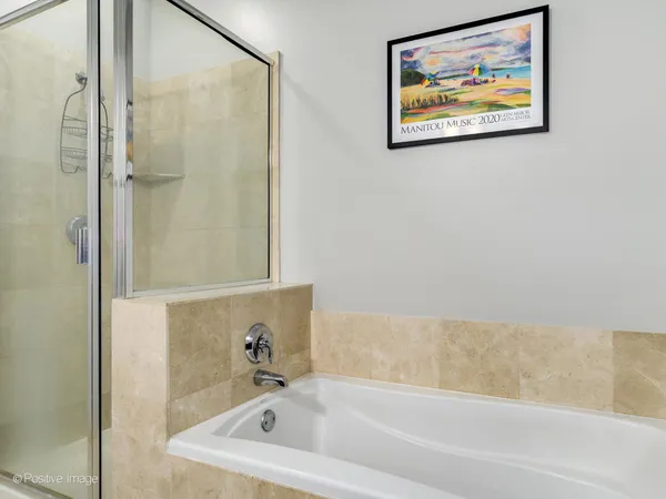 a bathroom with a bathtub and a shower