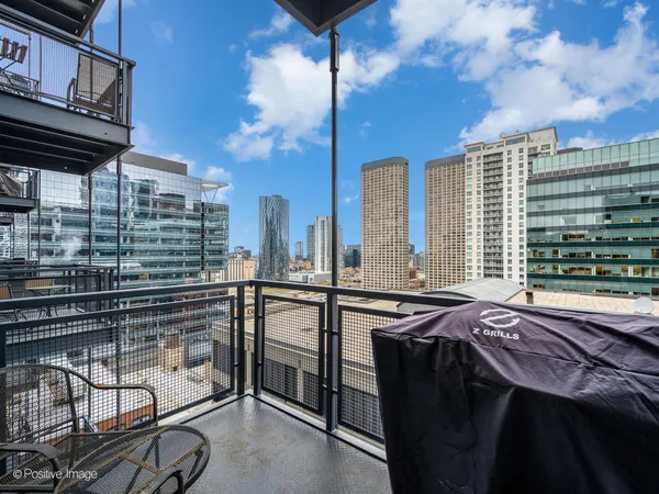 a view of a balcony dining table and chairs
