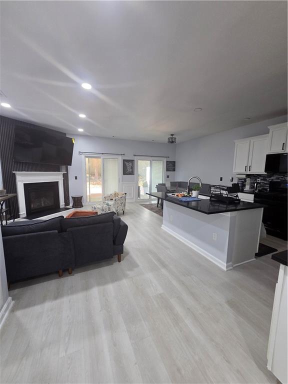 a living room with furniture and kitchen view