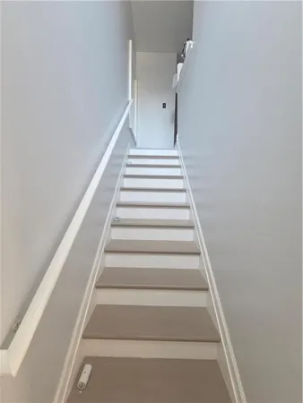 a view of staircase with white walls