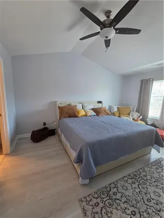 a bedroom with a bed and a ceiling fan