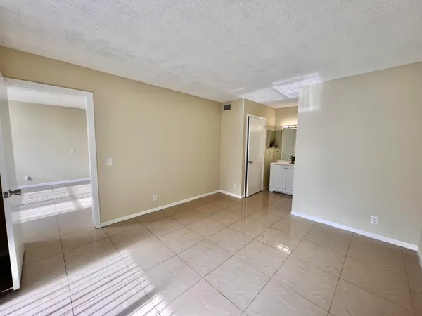 a view of an empty room and wooden floor