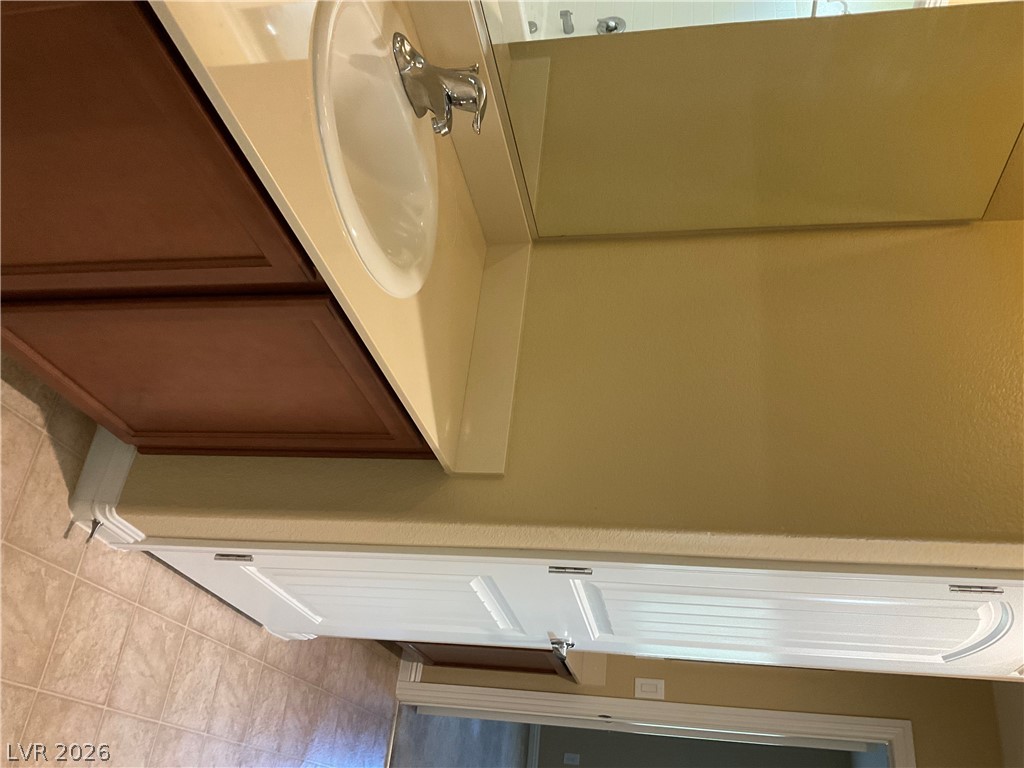 12 Jasmine Point Street Henderson, NV 89074 - Photo 9 of 15 A well-appointed bathroom vanity with a spacious countertop and practical storage below.