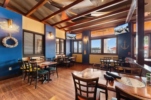 a view of a refrigerator in kitchen and an empty room