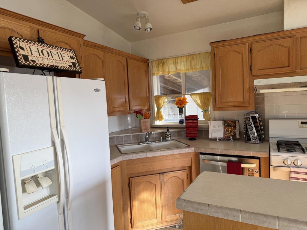 37697 Montezuma Valley Road Ranchita, CA 92066 - Photo 16 of 47 a kitchen with a refrigerator a sink and a stove top oven