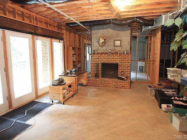 13917 Possum Track Road Raleigh, NC 27614 - Photo 12 of 12 The 1500 unfin basement is dry! There is a bath stubbed,masonary fireplace & electric outlets . The rec room opens to a patio Room (behind fireplace )has double doors, future work shop! Another room too! Basement