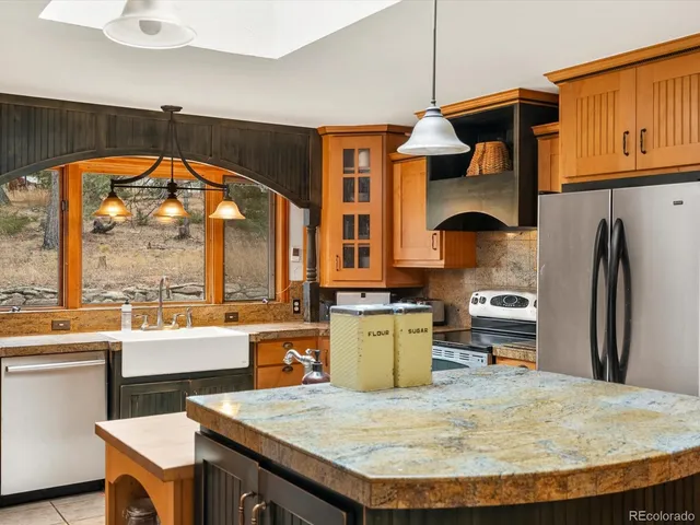 a kitchen with sink refrigerator and stove
