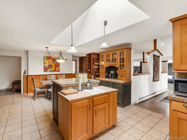 a kitchen with stainless steel appliances kitchen island granite countertop a sink and cabinets