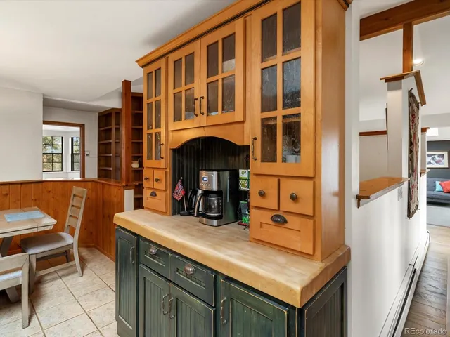 a view of kitchen with a sink and a refrigerator