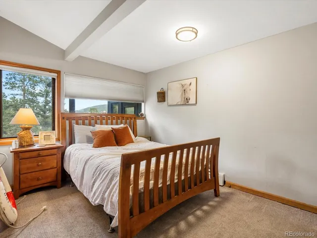 a bedroom with a bed and a lamp on table
