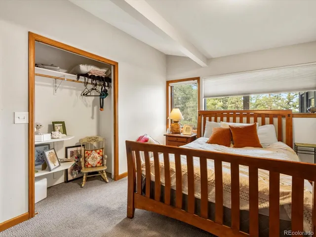 a bedroom with furniture and a window