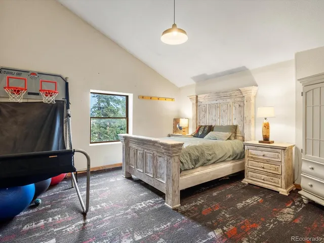 a bedroom with a bed chair and dresser