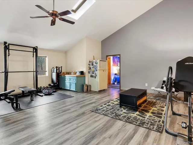 a view of a workspace with furniture and wooden floor