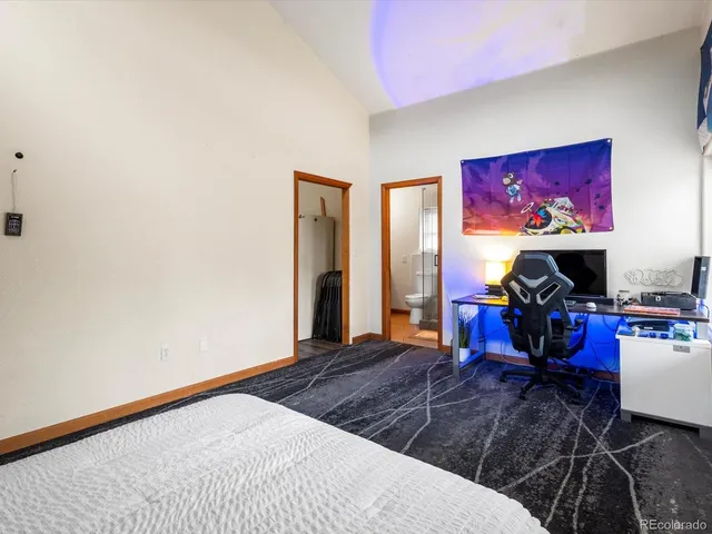 a living room with furniture a flat screen tv and a floor to ceiling window