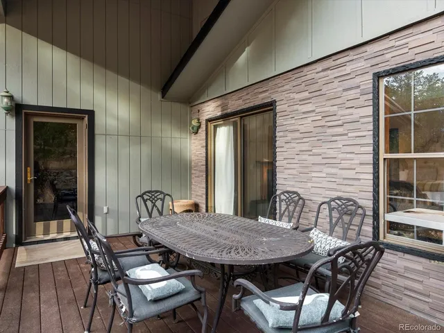 a view of a patio with table and chairs and potted plants