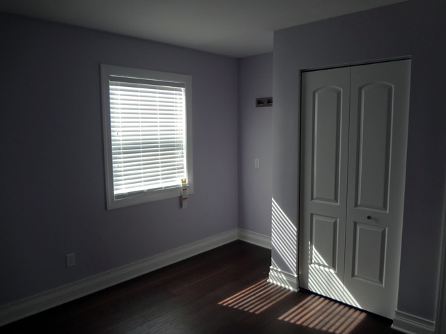 57 Stratford Road Montgomery, IL 60538 - Photo 13 of 15 a view of an empty room with wooden floor and a window