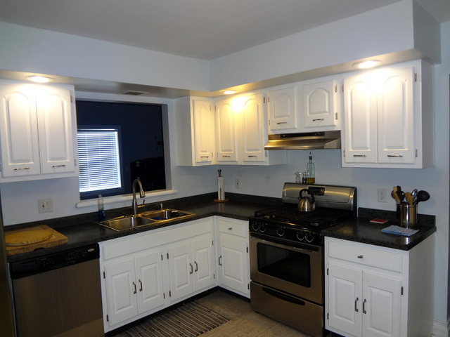 57 Stratford Road Montgomery, IL 60538 - Photo 6 of 15 a kitchen with granite countertop white cabinets and black appliances