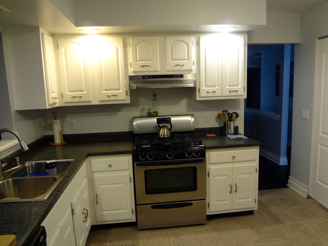57 Stratford Road Montgomery, IL 60538 - Photo 7 of 15 a kitchen with granite countertop white cabinets and stainless steel appliances