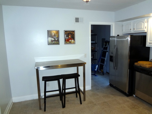 57 Stratford Road Montgomery, IL 60538 - Photo 8 of 15 a room with a table and refrigerator