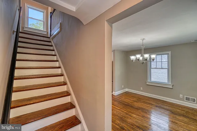 a view of entryway with wooden floor and a livingroom