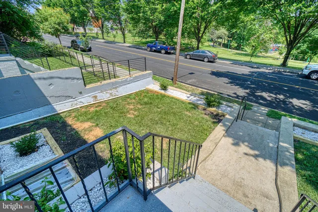 a view of empty room with wooden floor and fireplace