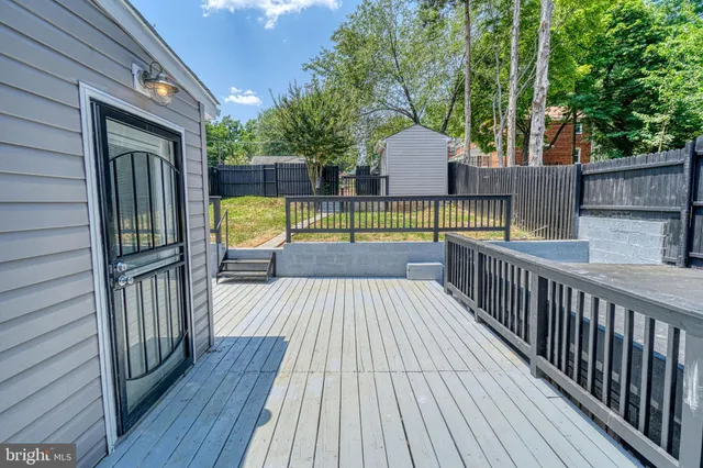 a view of a balcony with wooden floor and stairs