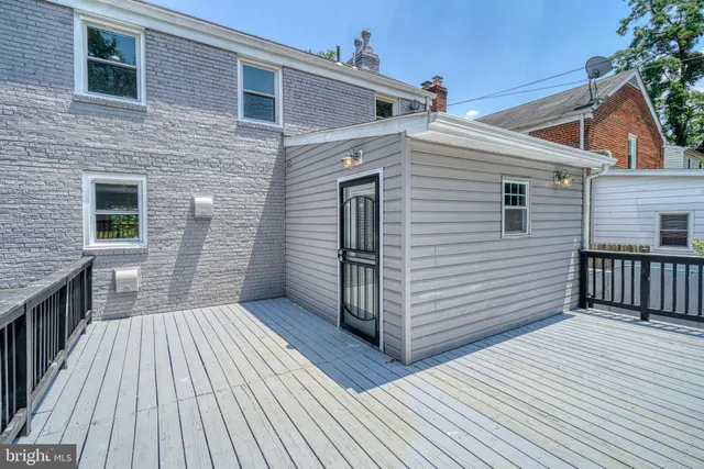 a view of balcony with wooden floor and seating space