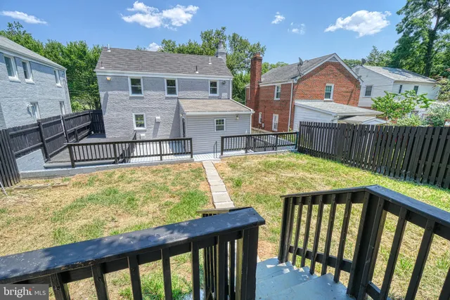 a view of a house with swimming pool and sitting area