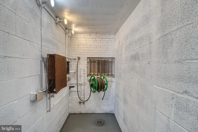 a view of hallway with a large window and wooden floor
