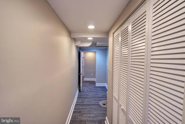 an empty room with wooden floor & closet