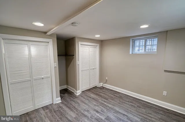 a view of staircase with wooden floor and fan